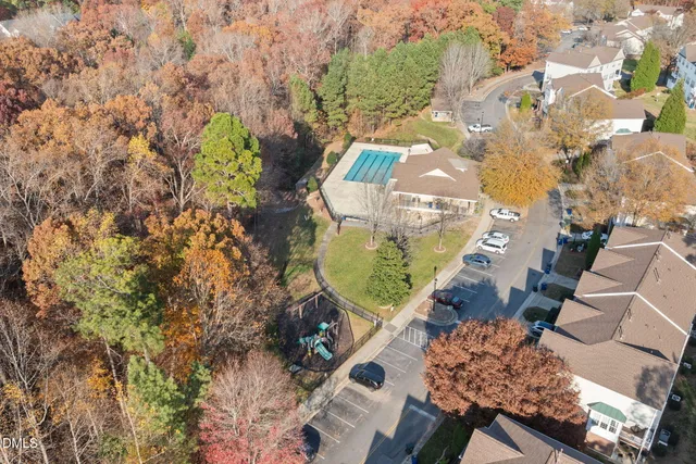 an aerial view of a house with a yard and garden