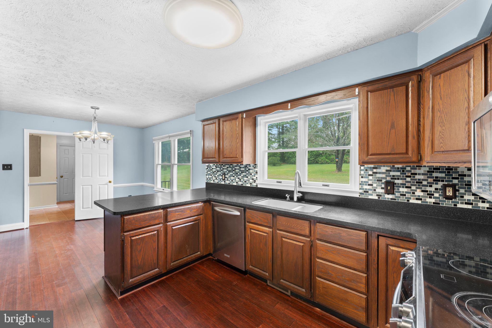 13360 Cameron Court Boston, VA 22713 - Photo 50 of 76 a kitchen with granite countertop a sink and cabinets
