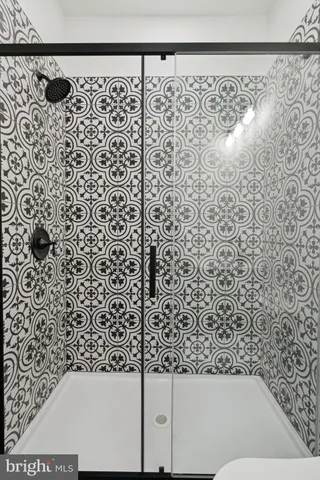 a bathroom with a bathtub and shower