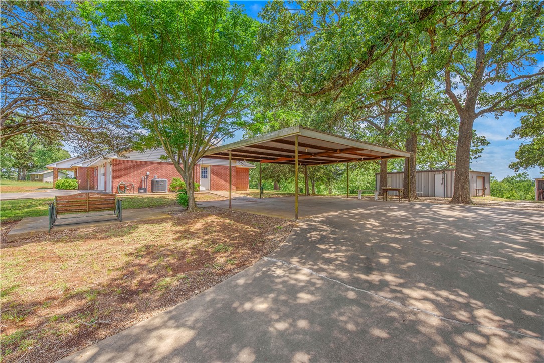 1110 County Road 439 Dime Box, TX 77853 - Photo 45 of 50 a backyard of a house with a table and chairs under an umbrella