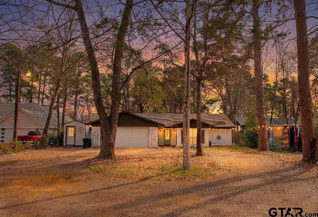 1339 Bridle Path Lane Hideaway, TX 75771 - Photo 1 of 41 a front view of a building with trees