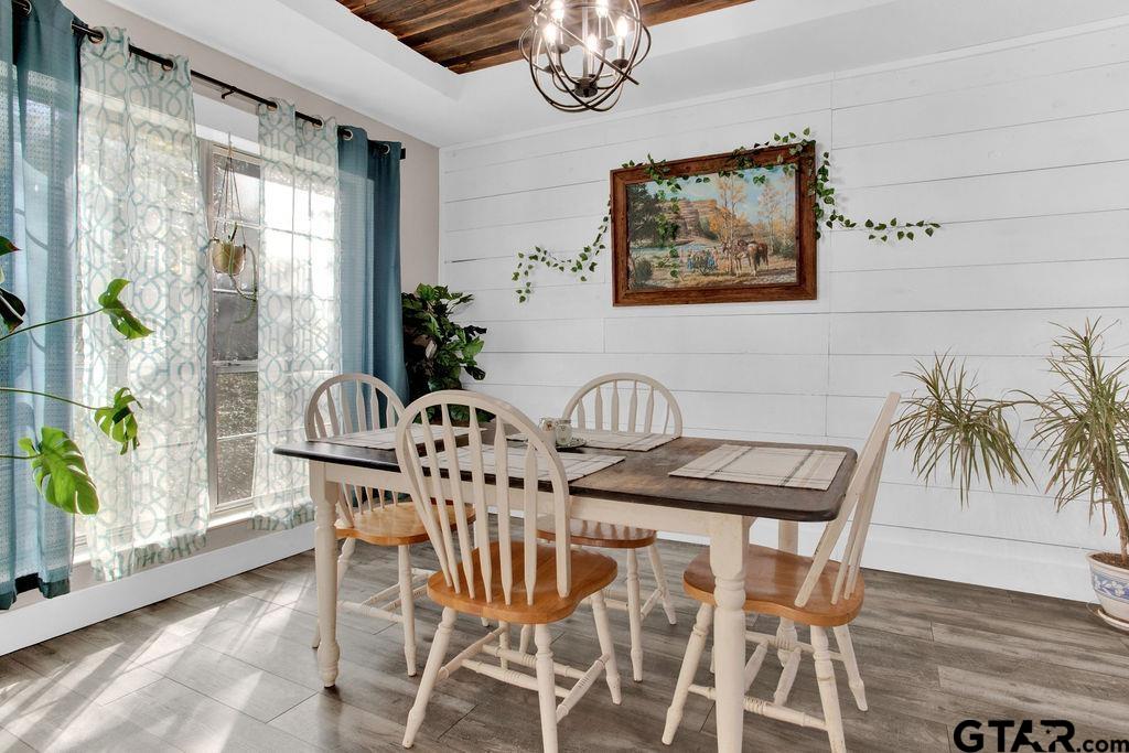 1339 Bridle Path Lane Hideaway, TX 75771 - Photo 17 of 41 a view of a dining room with furniture wooden floor and a chandelier
