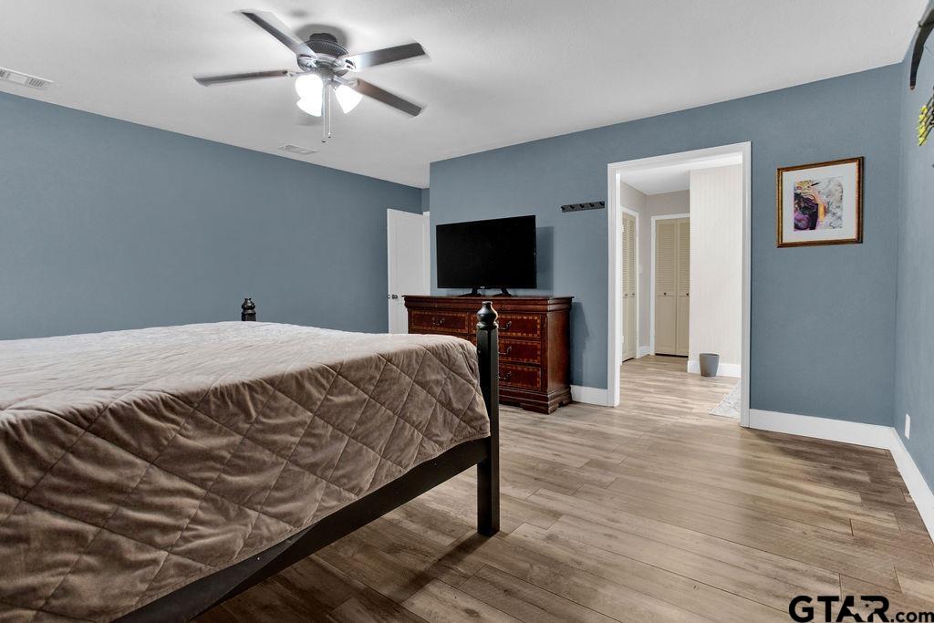 1339 Bridle Path Lane Hideaway, TX 75771 - Photo 22 of 41 a bedroom with a bed and a flat screen tv