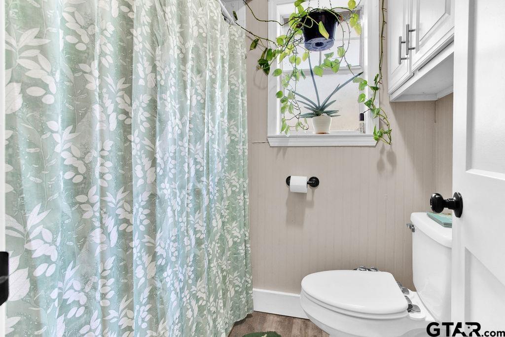 1339 Bridle Path Lane Hideaway, TX 75771 - Photo 26 of 41 a white toilet sitting next to a shower curtain
