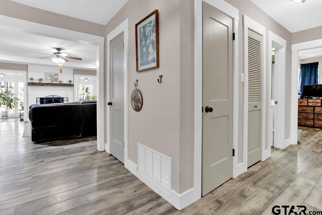 1339 Bridle Path Lane Hideaway, TX 75771 - Photo 27 of 41 a view of a hallway with wooden floor and staircase