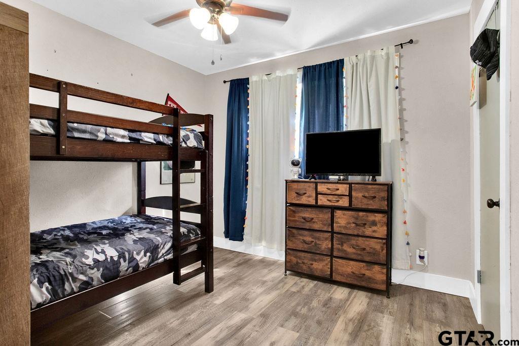 1339 Bridle Path Lane Hideaway, TX 75771 - Photo 28 of 41 a bedroom with furniture and flat screen tv