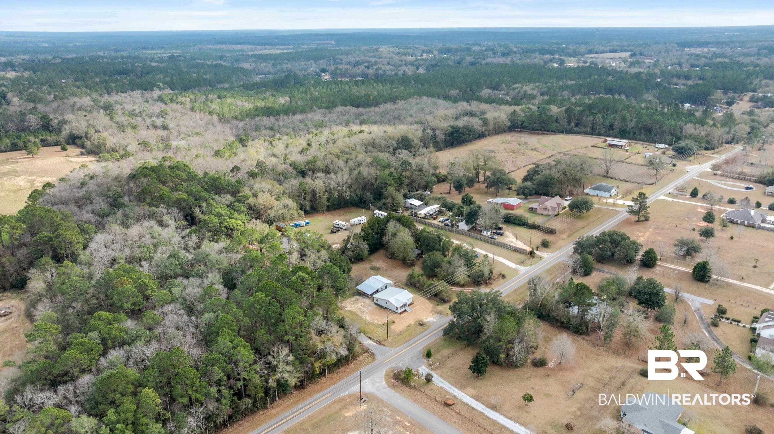 35780 Spring Road North Stapleton, AL 36578 - Photo 29 of 41 Aerial view of property and surrounding area with a heavily wooded area