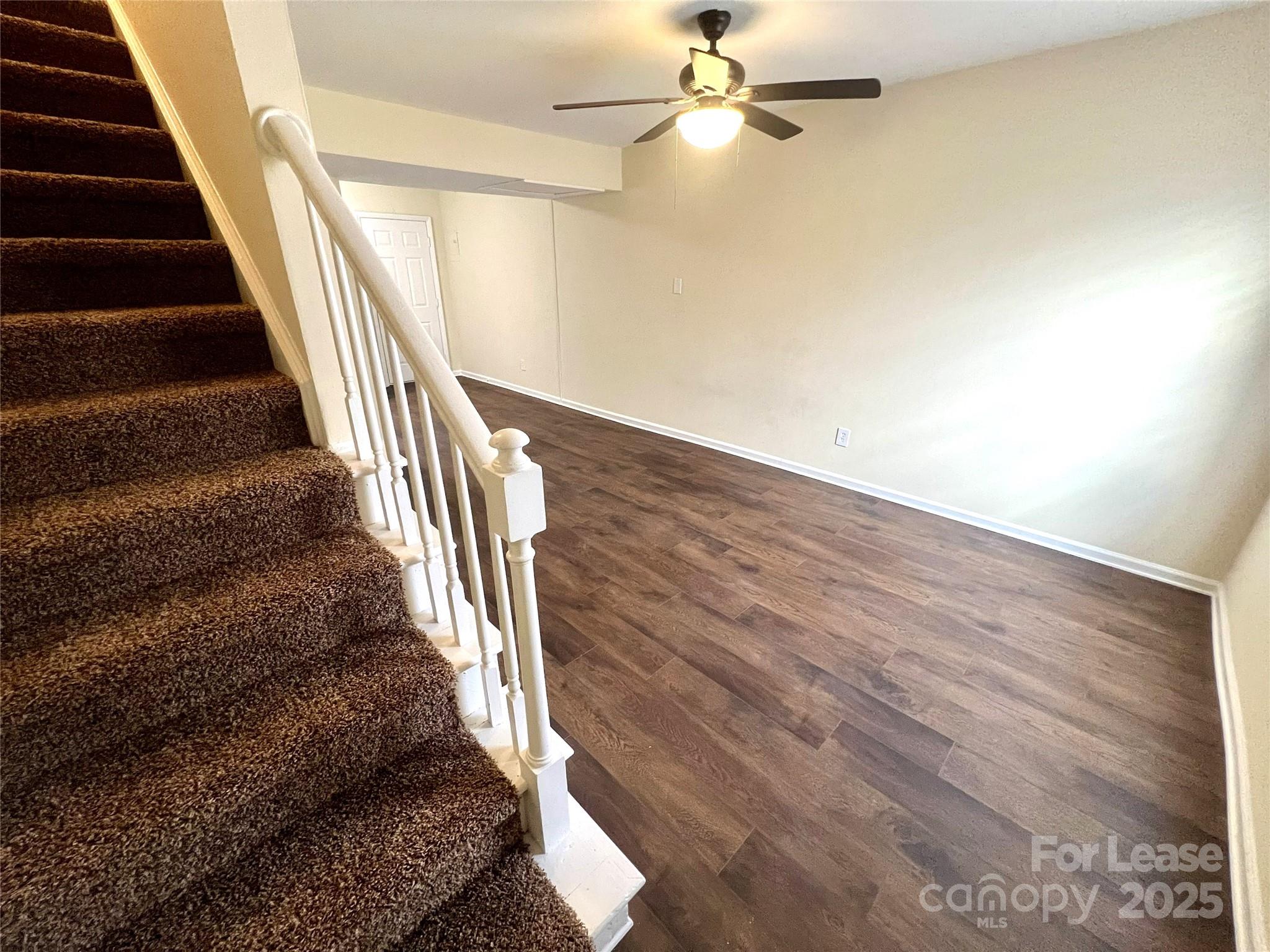 250 Nixon Road, Unit 34 Belmont, NC 28012 - Photo 2 of 11 wooden floor in an empty room with a staircase