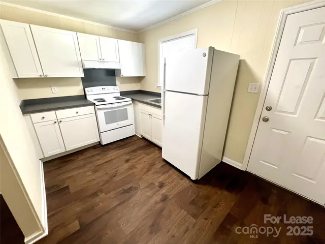 a kitchen with a refrigerator a stove a sink and a window