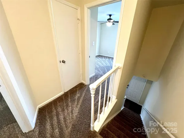 a view of a hallway view with wooden floor and staircase