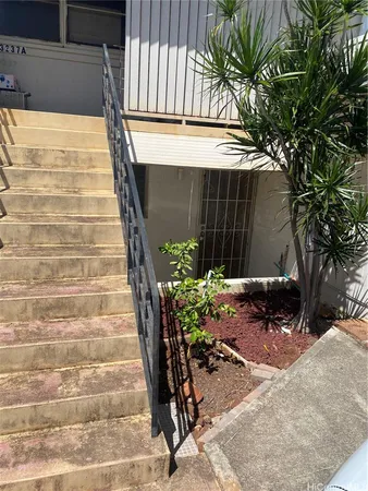 a view of a pathway of a house with a bench