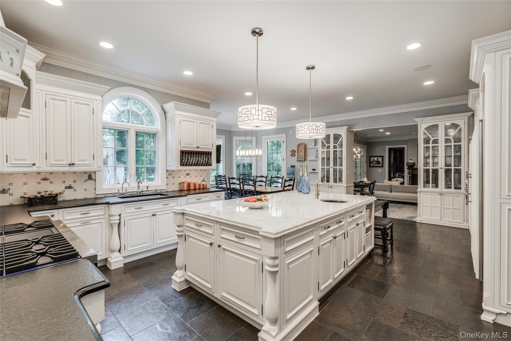178 Brookville Road Muttontown, NY 11545 - Photo 12 of 29 a large white kitchen with a large island oven a stove and a sink