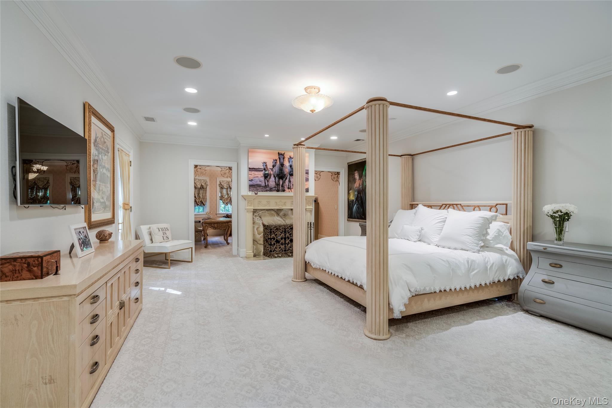 178 Brookville Road Muttontown, NY 11545 - Photo 13 of 29 a spacious bedroom with a bed and a flat tv screen on wall