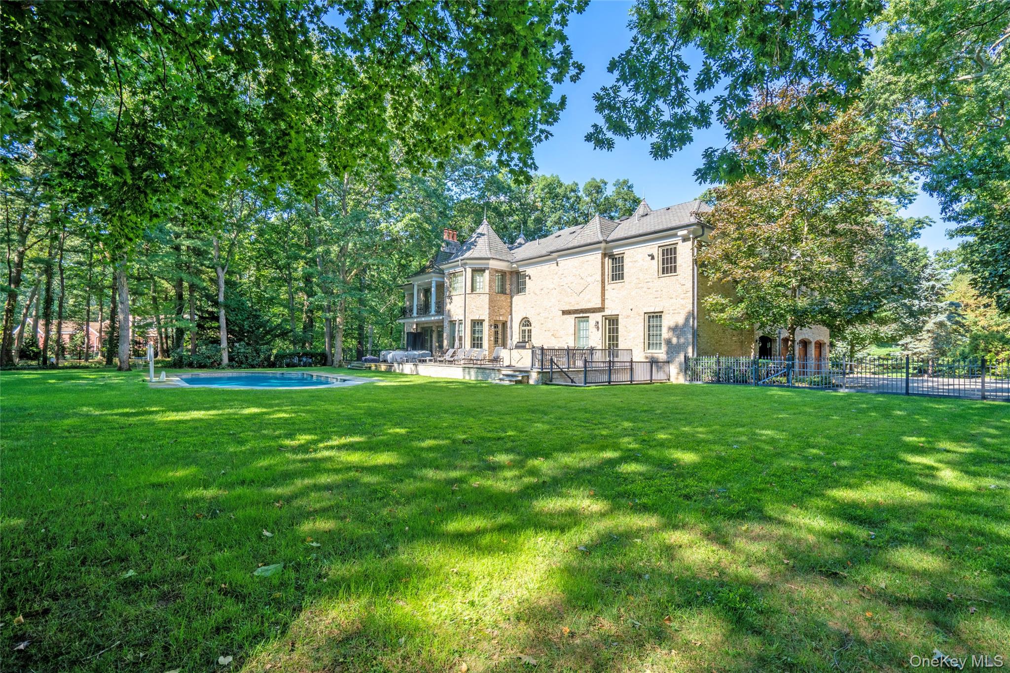 178 Brookville Road Muttontown, NY 11545 - Photo 26 of 29 a view of a white house in front of a big yard with large trees