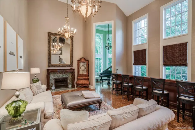 a living room with furniture fireplace and a large window
