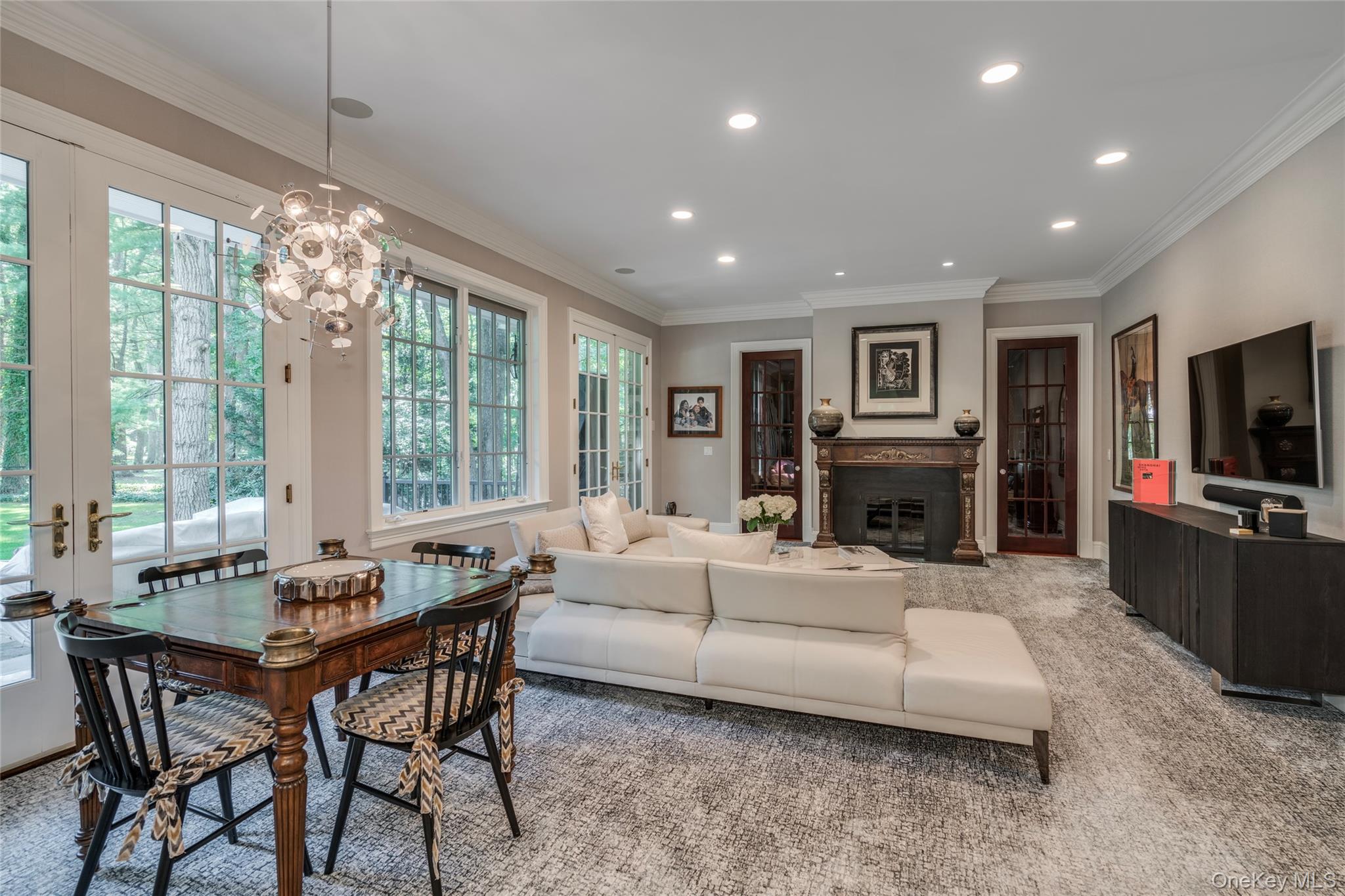 178 Brookville Road Muttontown, NY 11545 - Photo 7 of 29 a living room with furniture a large window and a flat screen tv