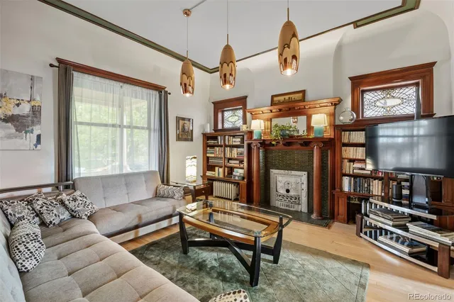 a dining room with furniture a chandelier and wooden floor