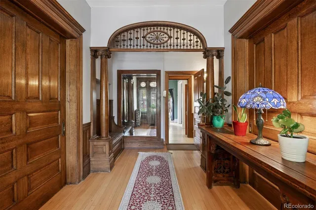 a view of a dining room with furniture a chandelier and windows