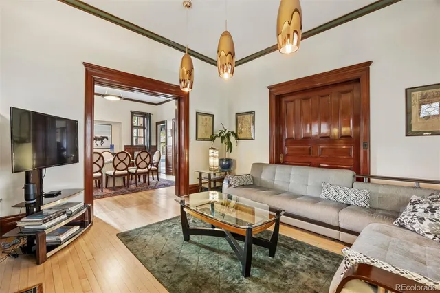 a dining room with furniture and wooden floor