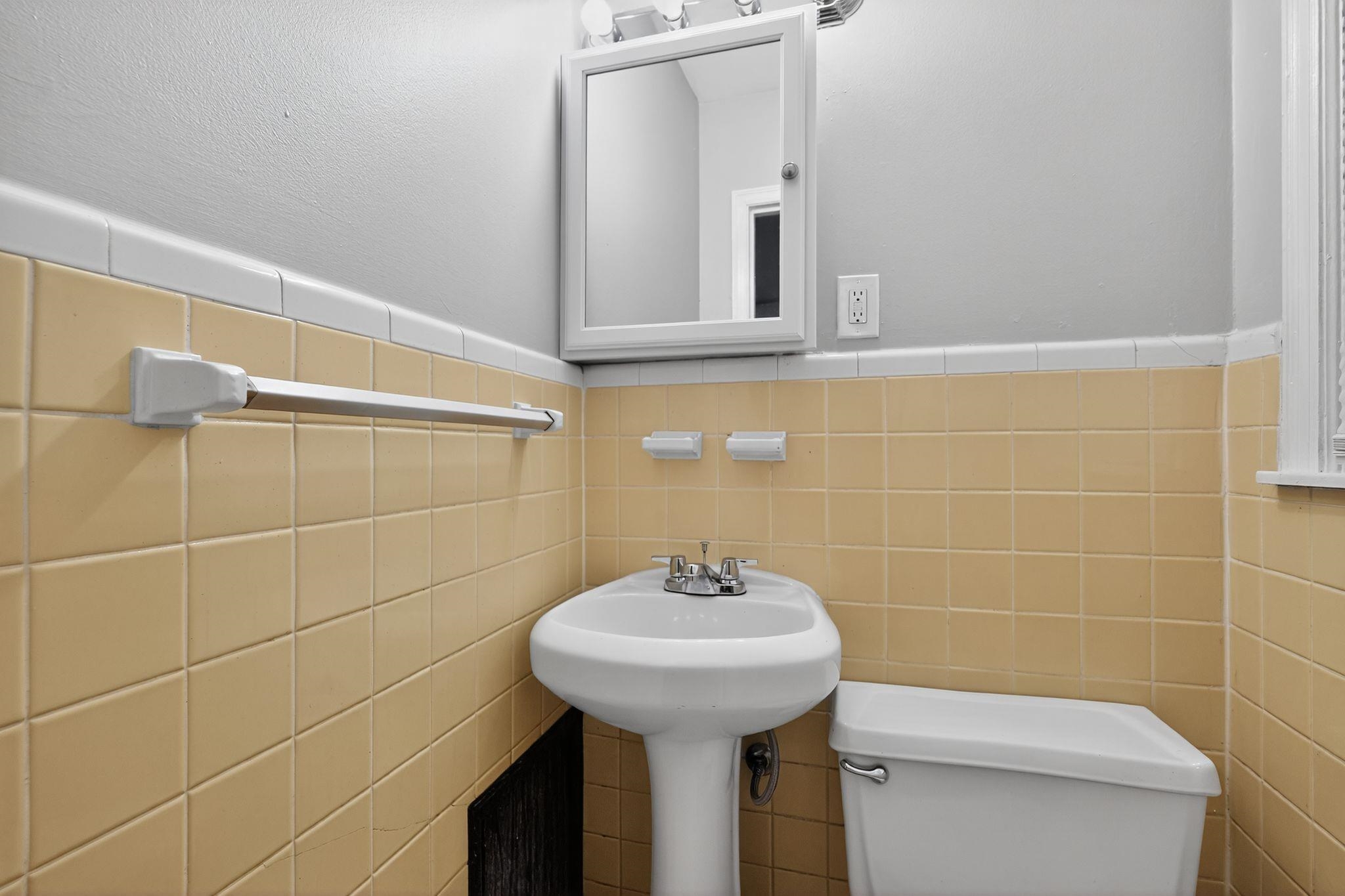 177 East Raines Road Memphis, TN 38109 - Photo 27 of 32 Half bathroom featuring wainscoting and tile walls