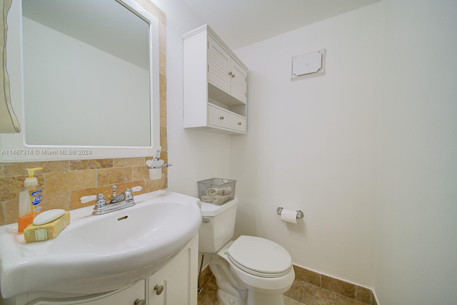 Edgewater Miami, FL 33137 - Photo 6 of 27 a bathroom with a sink a toilet and mirror