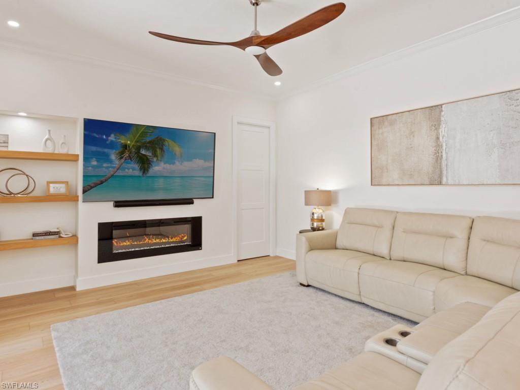 206 Palmetto Dunes Circle Naples, FL 34113 - Photo 33 of 34 a living room with furniture and a flat screen tv