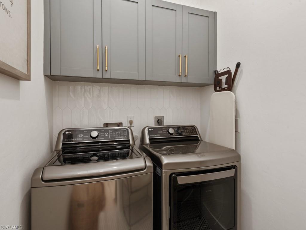 206 Palmetto Dunes Circle Naples, FL 34113 - Photo 14 of 34 a utility room with dryer and washer