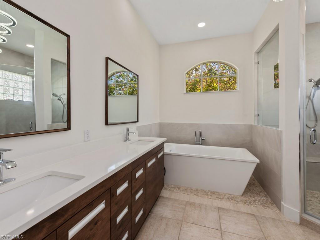 206 Palmetto Dunes Circle Naples, FL 34113 - Photo 17 of 34 a bathroom with a sink and a bathtub