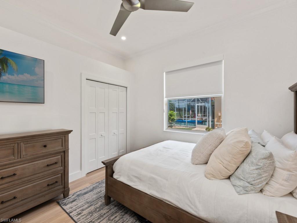 206 Palmetto Dunes Circle Naples, FL 34113 - Photo 20 of 34 a bedroom with a bed and a window