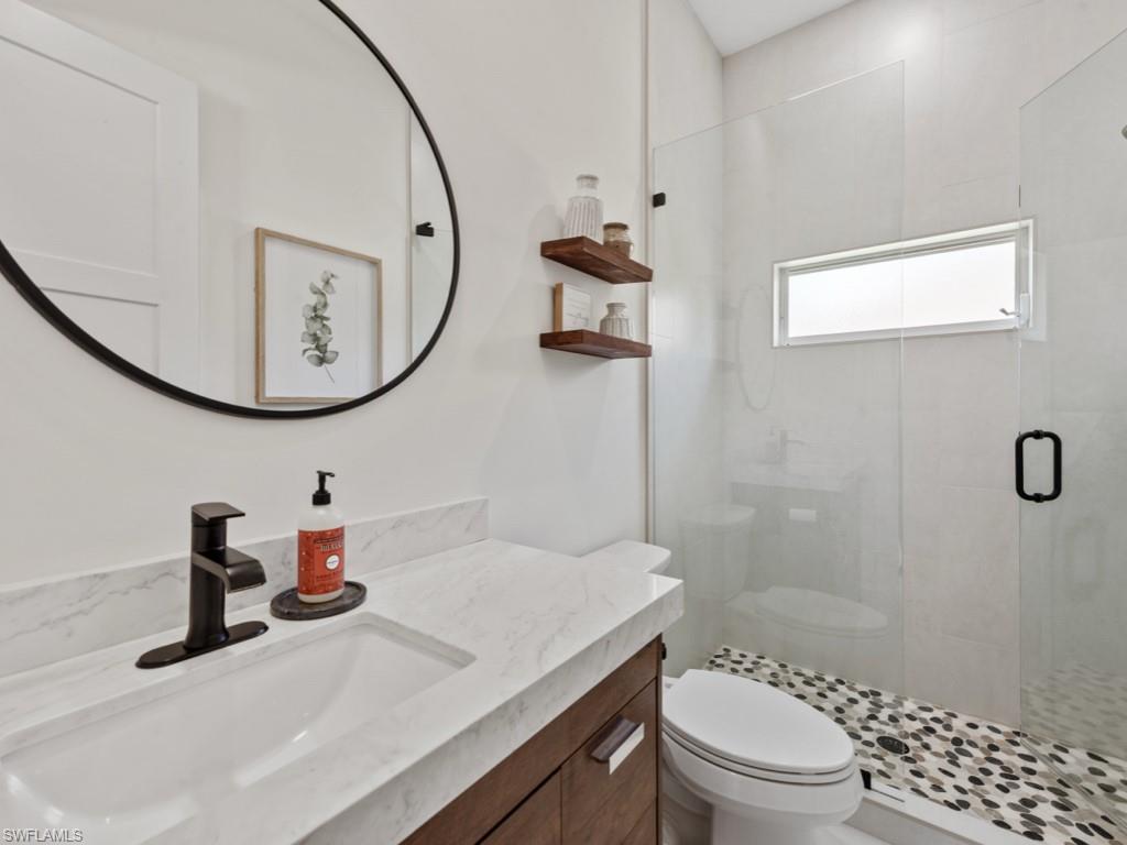 206 Palmetto Dunes Circle Naples, FL 34113 - Photo 21 of 34 a bathroom with a sink a toilet and shower