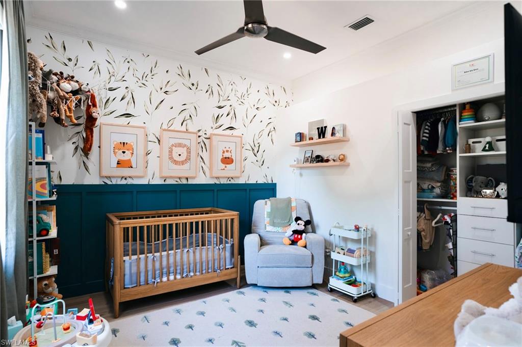 206 Palmetto Dunes Circle Naples, FL 34113 - Photo 23 of 34 a bedroom with baby bed and a window
