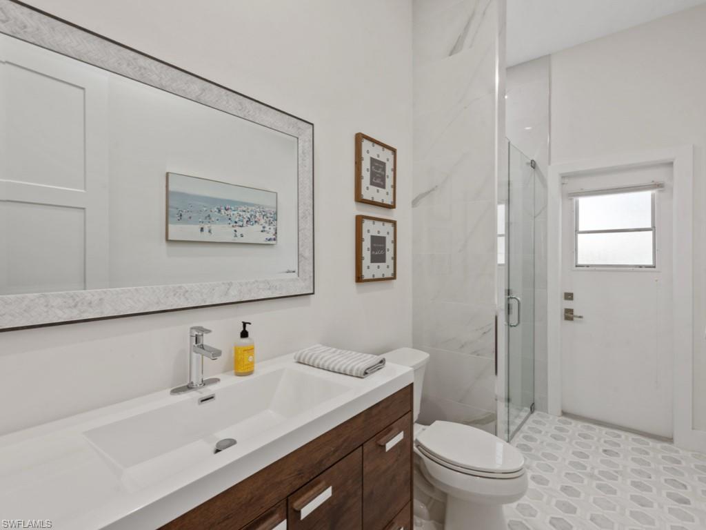 206 Palmetto Dunes Circle Naples, FL 34113 - Photo 24 of 34 a bathroom with a sink a toilet and shower