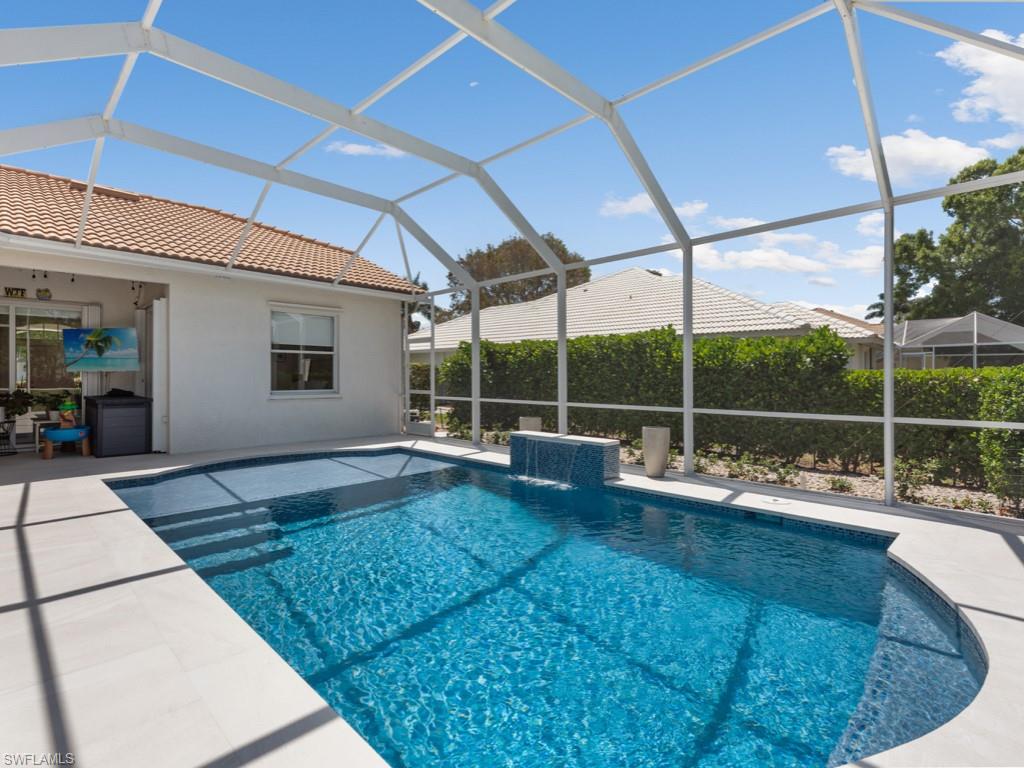206 Palmetto Dunes Circle Naples, FL 34113 - Photo 26 of 34 a view of a swimming pool with a patio