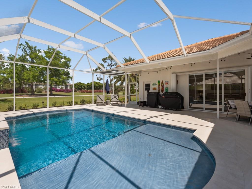 206 Palmetto Dunes Circle Naples, FL 34113 - Photo 29 of 34 a view of a patio with a table and chairs and potted plants