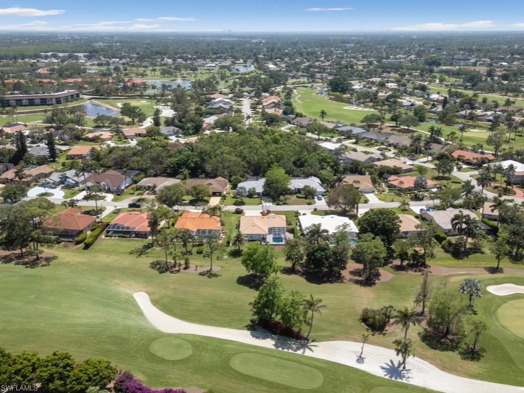 206 Palmetto Dunes Circle Naples, FL 34113 - Photo 4 of 34 an aerial view of residential houses with outdoor space and trees
