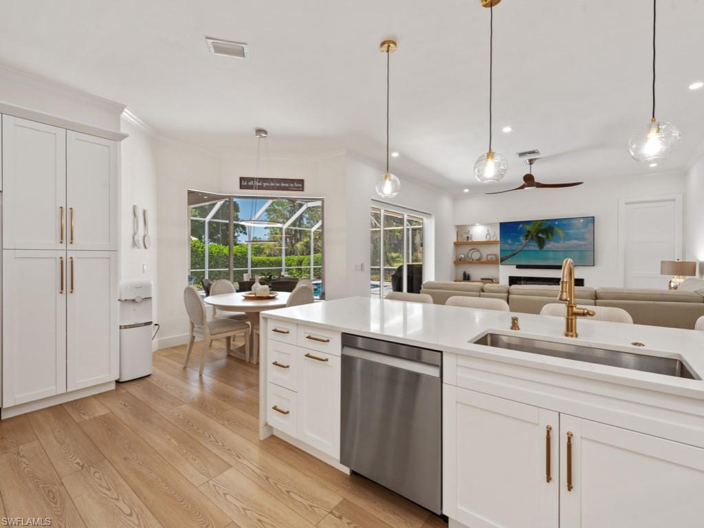 206 Palmetto Dunes Circle Naples, FL 34113 - Photo 6 of 34 a kitchen with appliances cabinets and a wooden floor