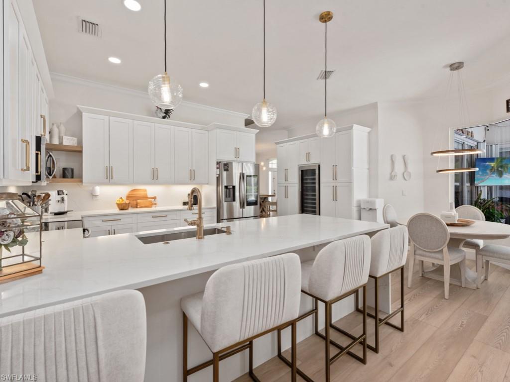 206 Palmetto Dunes Circle Naples, FL 34113 - Photo 7 of 34 a large kitchen with a table and chairs