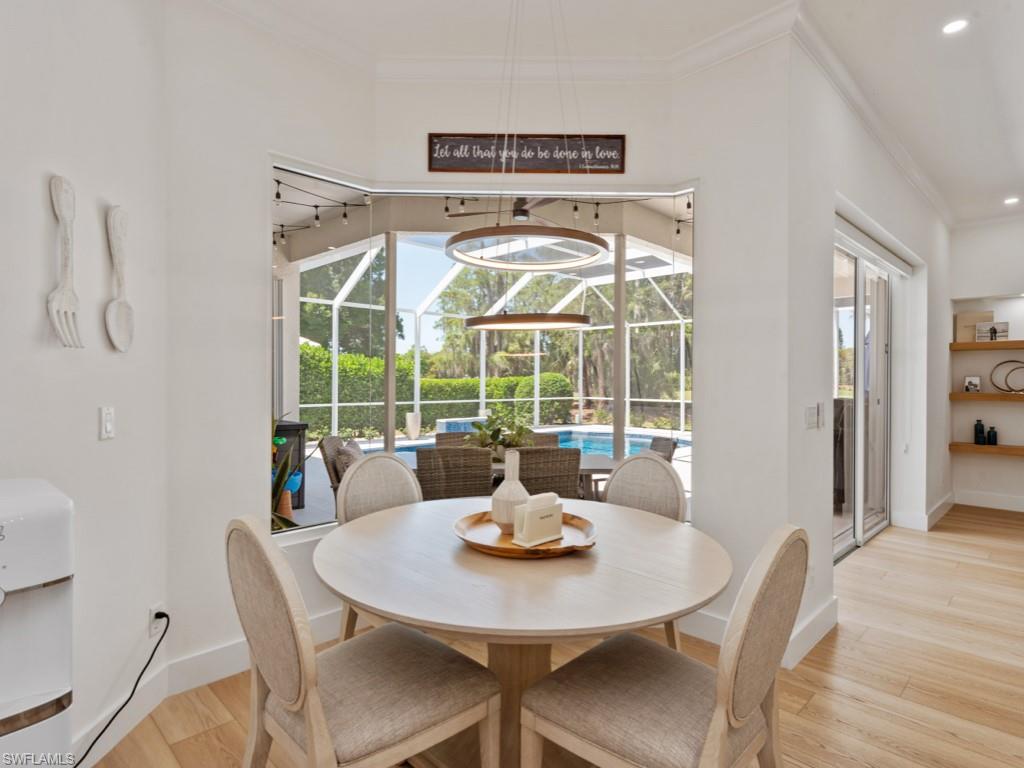 206 Palmetto Dunes Circle Naples, FL 34113 - Photo 10 of 34 a view of a dining room with furniture wooden floor and a chandelier