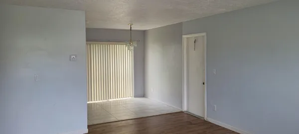 an empty room with closet and wooden floor