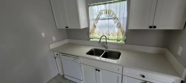 a kitchen with a sink and cabinets