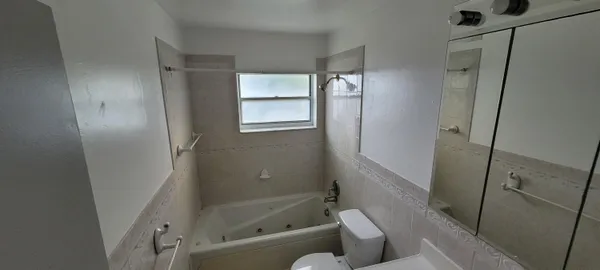 a bathroom with a tub and a shower