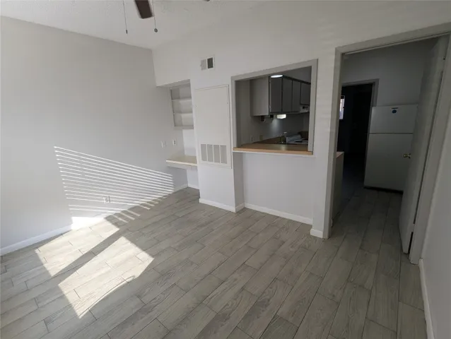 a kitchen with stainless steel appliances a sink dishwasher stove refrigerator and cabinets