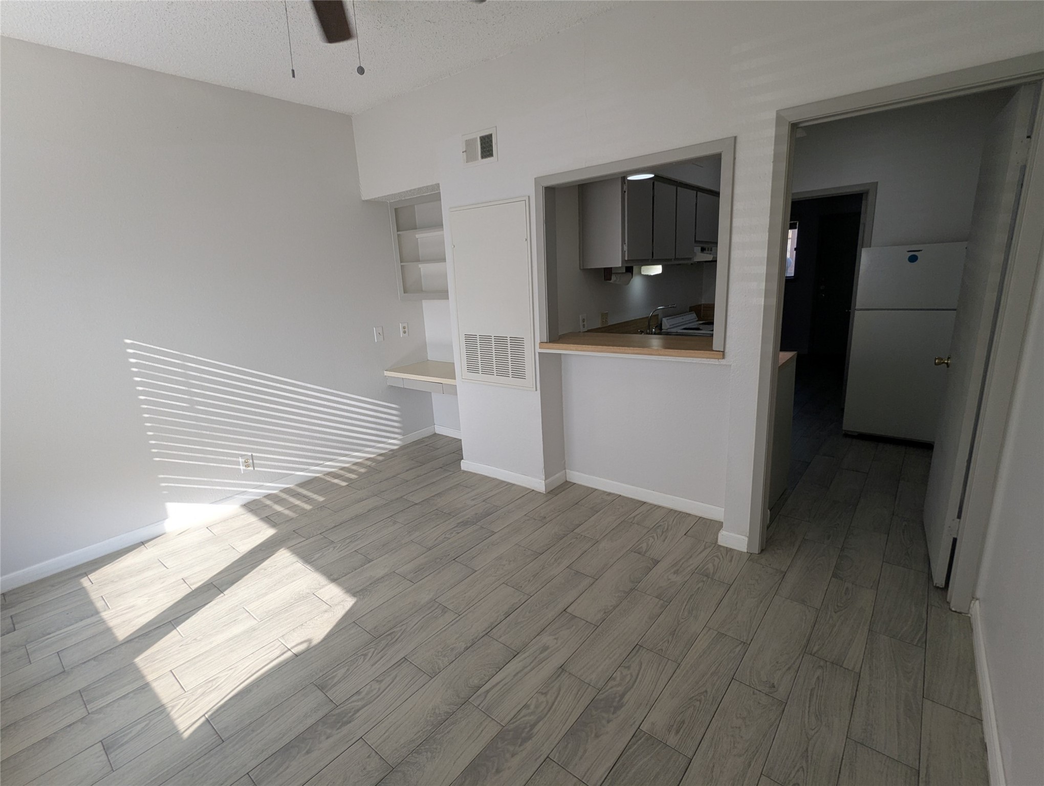 3000 Guadalupe Street, Unit 112 Austin, TX 78705 - Photo 5 of 9 a view of hallway with wooden floor and cabinets