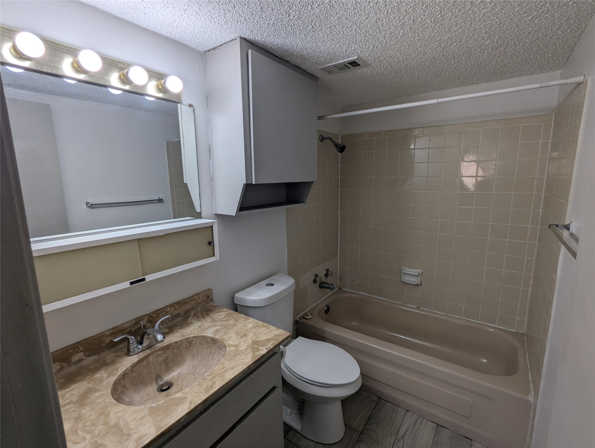 3000 Guadalupe Street, Unit 112 Austin, TX 78705 - Photo 7 of 9 a bathroom with a sink toilet a mirror and shower