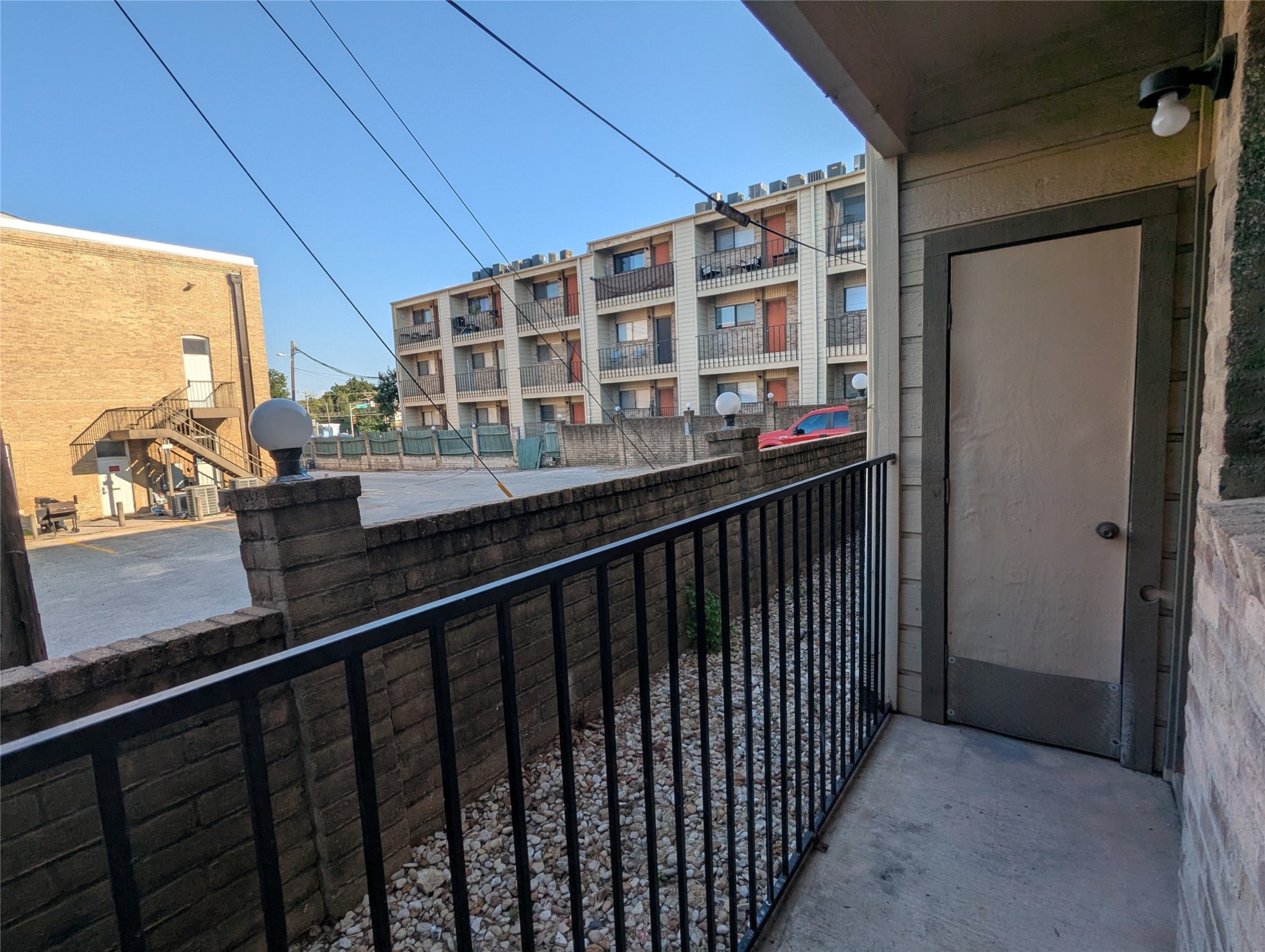 3000 Guadalupe Street, Unit 112 Austin, TX 78705 - Photo 8 of 9 a view of a balcony with wooden floor and city view