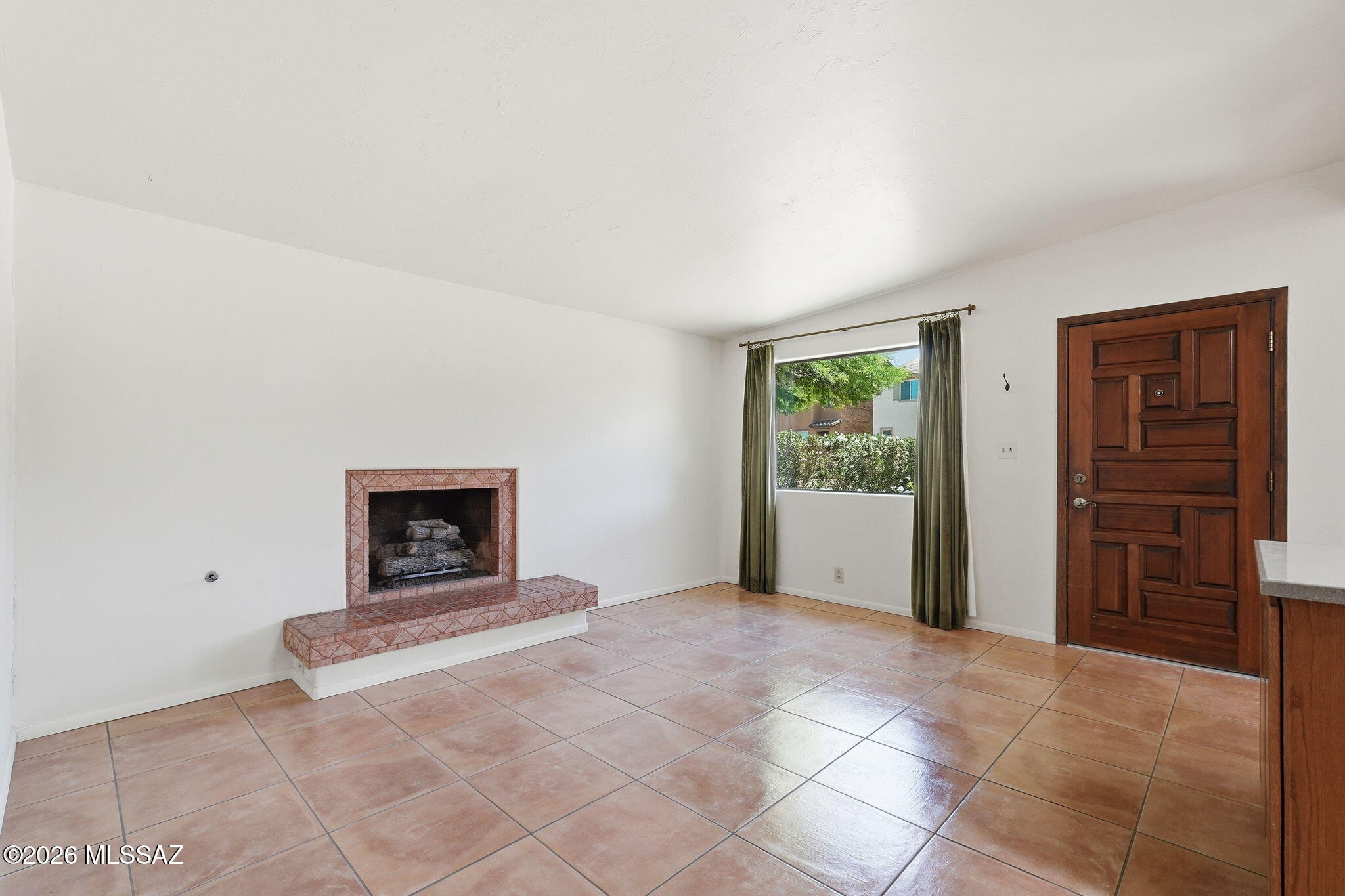 1125 East Kleindale Road Tucson, AZ 85719 - Photo 5 of 49 a view of an empty room with window and fireplace