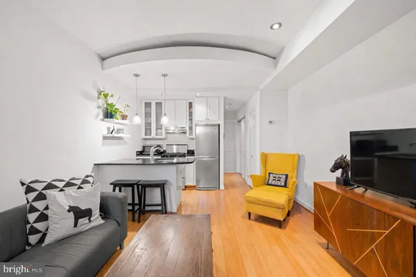 a living room with furniture and a wooden floor