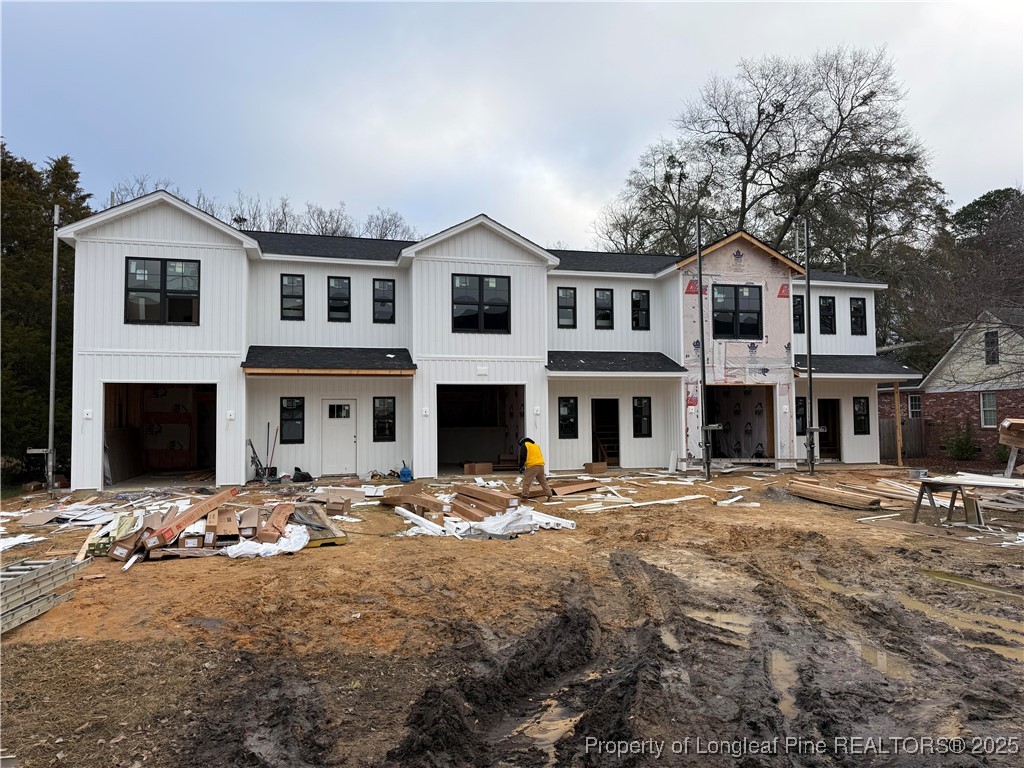 a front view of a building with cars parked