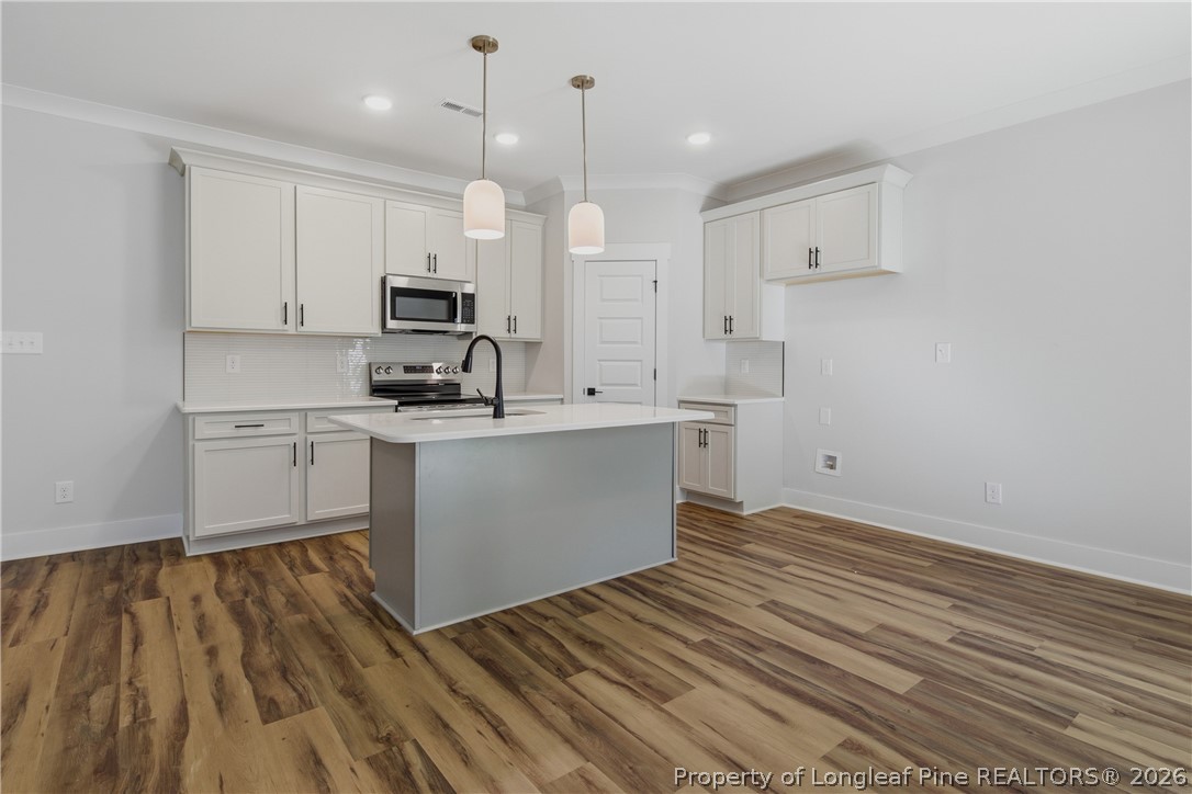 3931 Hamilton Street Hope Mills, NC 28348 - Photo 17 of 50 a kitchen with white cabinets and sink