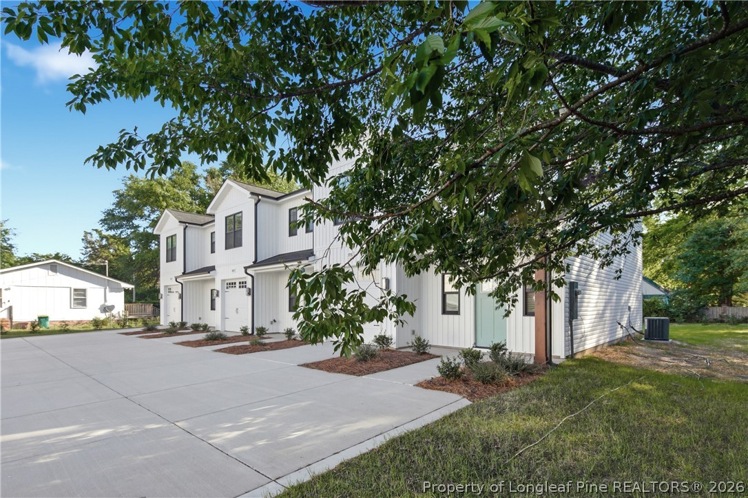 3931 Hamilton Street Hope Mills, NC 28348 - Photo 2 of 50 a view of city street with a building and trees in the background